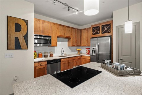 a kitchen with wooden cabinets and a granite counter top
